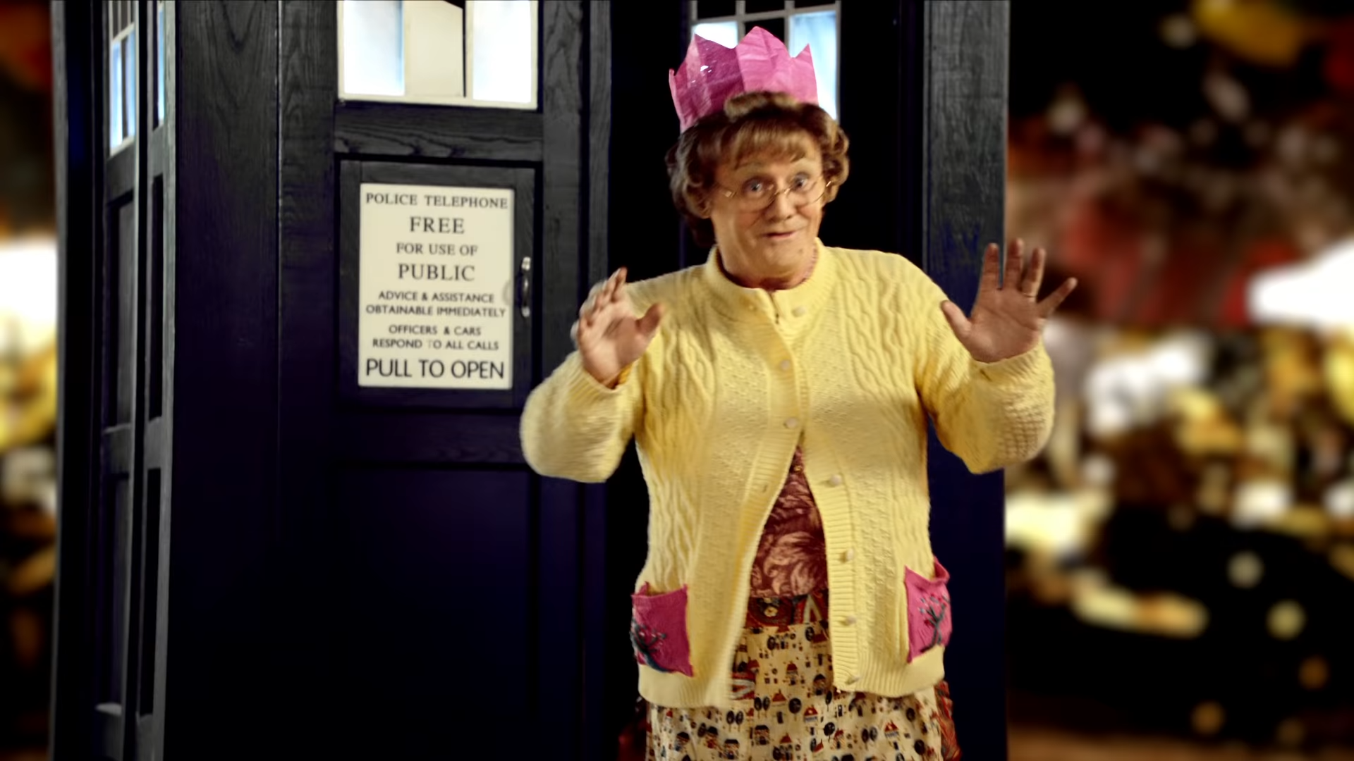 Agnes stands outside of the TARDIS.