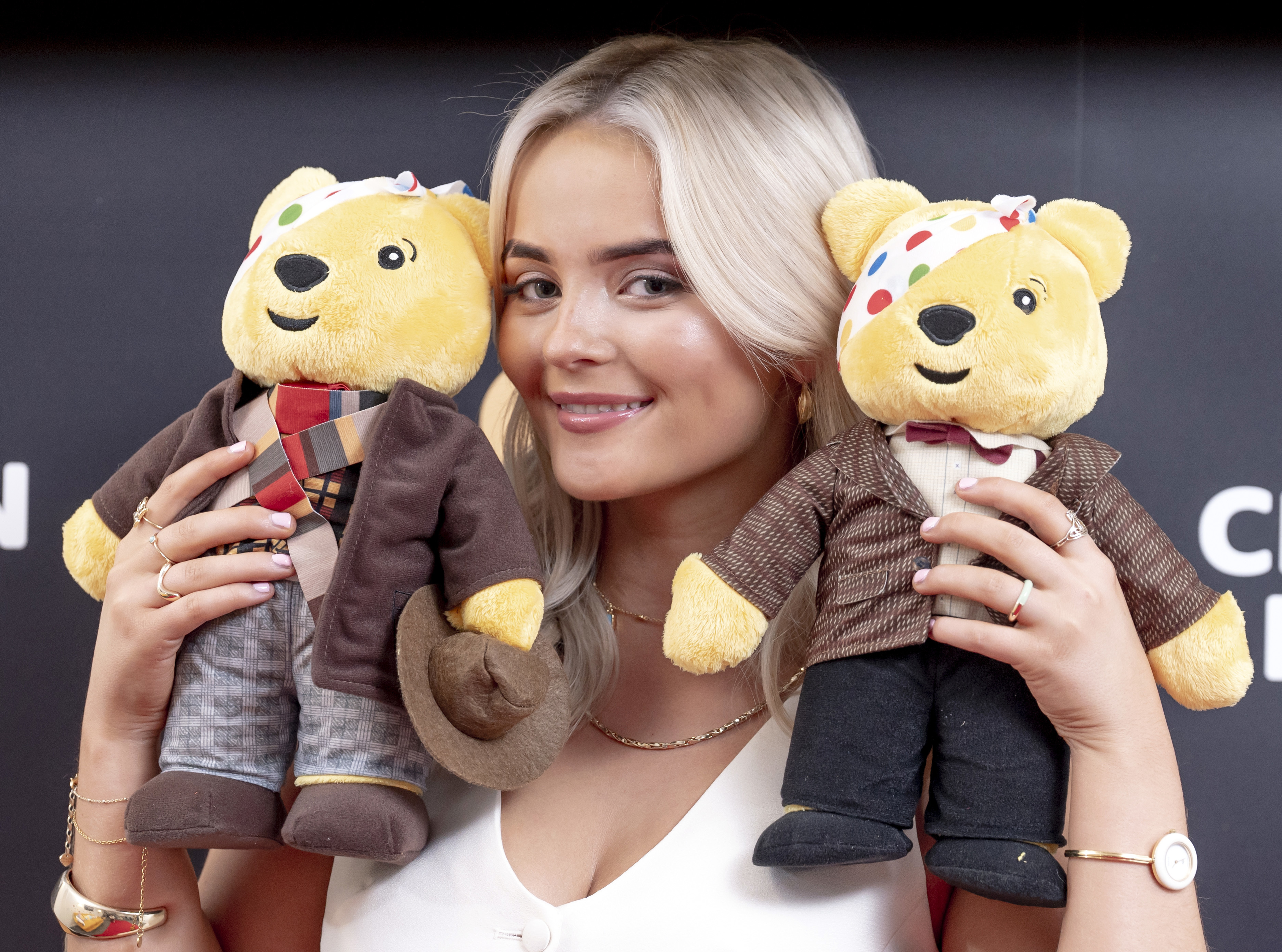 Millie Gibson with two Pudsey plushies of the Fourth and Eleventh Doctors