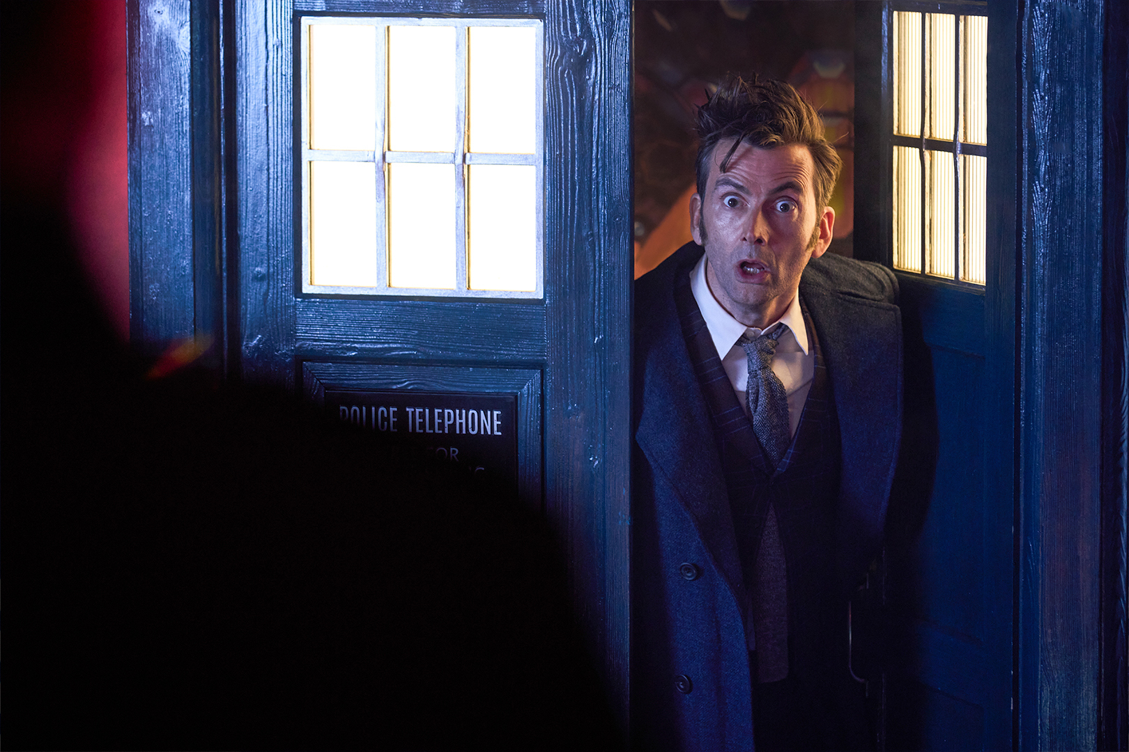 The Doctor exits his TARDIS.