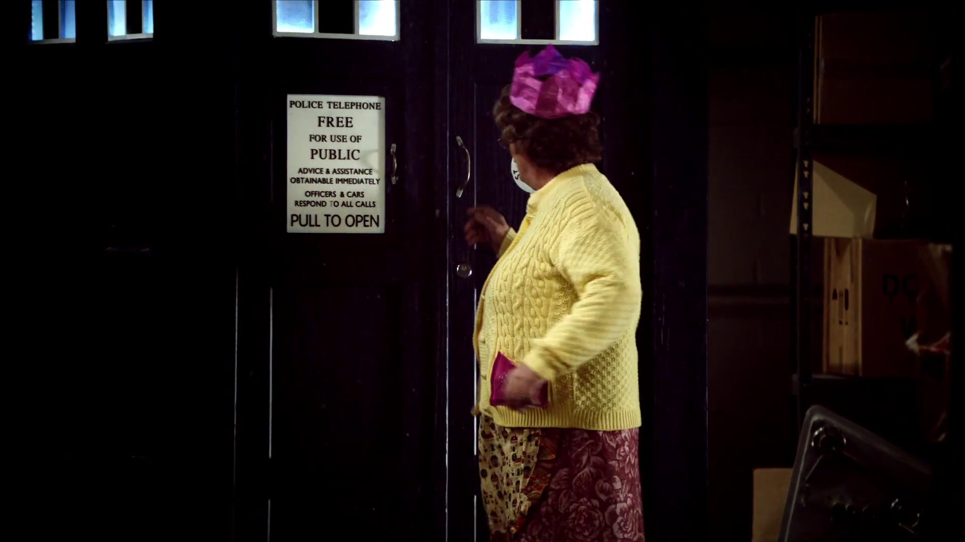 Agnes reaches to open the TARDIS doors.