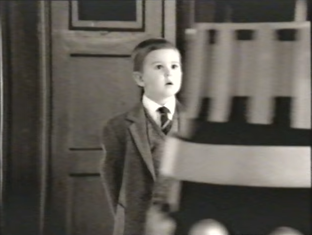 The boy watches the Daleks move past. (TV: Future Generations [+]Loading...["Future Generations (TV story)"])