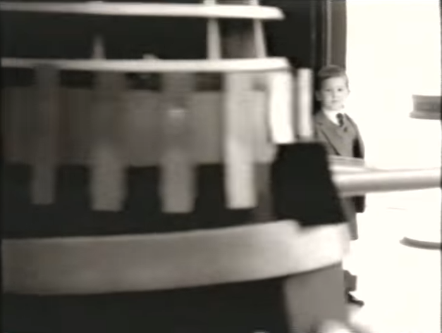 A Dalek rolls past the boy. (TV: Future Generations [+]Loading...["Future Generations (TV story)"])
