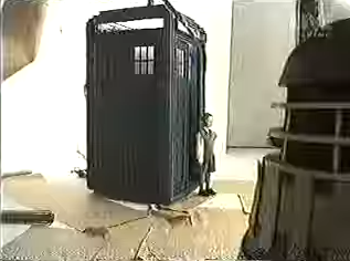 Screenshot of Scott Chisholm with the TARDIS and a Dalek on the set of Future Generations [+]Loading...["Future Generations (TV story)"]. (DOC: Live & Kicking)