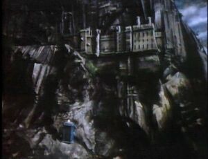 TARDIS materialises on Peladon castle in background.jpg