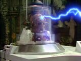 Davros continues shooting lightning at Orcini from his bionic eye.