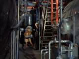 The Doctor and Liz carry the device into the heart of the factory.