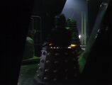 An ecstatic Davros zooms through the ruined corridors, Daleks following silently behind him.