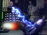 Now hovering, Davros electrocutes Orcini.