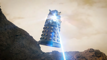 The Dalek is struck by a blast from the gunstick.