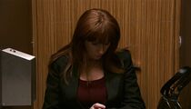 Donna enters a toilet stall.