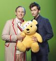 Pudsey with Peter Davison (the Fifth Doctor) and David Tennant (the Tenth Doctor) on the set of TV: Time Crash.