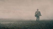 A child is spotted running through the mist on a battlefield.