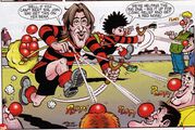 Dennis the Menace and Jonathan Ross use slingshots to launch Red Noses onto the residents of Beanotown.