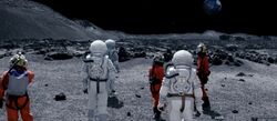 Clara, The Doctor, and Courtney Woods stand on the surface of the Moon.