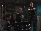 Davros discusses the Movellan War with Lytton as an engineer tends to his life-support system.