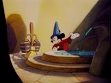 Mickey presents the fountain to the broom.