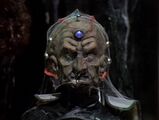 Davros's head covered in cobwebs.