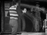 The Toymaker materialises in ront of Steven to prevent him from getting to the TARDIS without winning the game first.