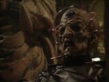 Davros reveals his real body's presence to Orcini.