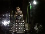 An indignant Davros is literally pushed around by the Doctor.