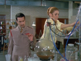 The Brigadier watches Liz getting settled in her new laboratory.