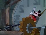 Mickey cleaning a cog inside the clock.