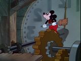 Mickey notices Donald Duck having difficulty on the mainspring.