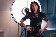 Davina McCall stands with her hands on her hips.