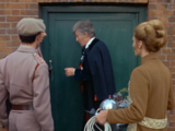 The Doctor, the Brigadier and Liz prepare to break into Auto Plastics through the back door.