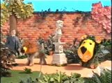 A boy walks through a garden, while Parsley the Lion and Dill the Dog are also present.