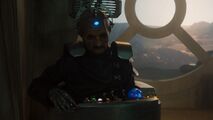 Davros watches Missy and the Doctor.