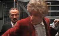 The Master hovers ominously behind the Third Doctor