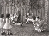 A boy continues to walk through the garden.