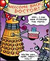 A Dalek holds a cake with a TARDIS decoration in its centre.