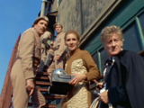 Halfway up a service stairway, the Doctor, Liz and the Brigadier look down at an approaching group, mistakenly believing them to be reinforcements.