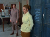 Liz leans nonchalantly against the TARDIS as the Brigadier confronts her for her shenanigans.