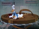 The mainspring pokes Donald Duck's posterior.