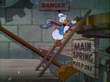 Donald climbs onto the mainspring with his mop.