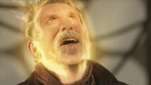 The Ninth Doctor begins to emerge from the War Doctor's regeneration.