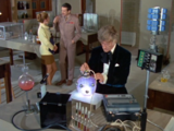 Back in the lab, Liz and the Brigadier talk while the Doctor runs some more tests on the energy unit.