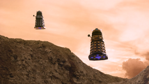 A pair of Daleks appear over a hill. Daleks: "Exterminate! Exterminate!"