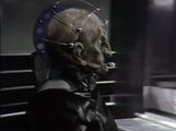 Side view of Davros's head as he gyrates to face the Fourth Doctor.