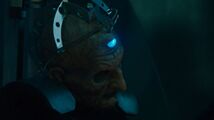 Davros looks wearily up at the Doctor.