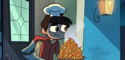 Marco Diaz, holding a plate of nachos, opens the door.