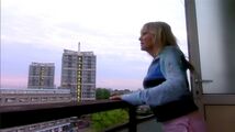 Jackie Tyler stands on the balcony of Mickey Smith's flat in Napier House.